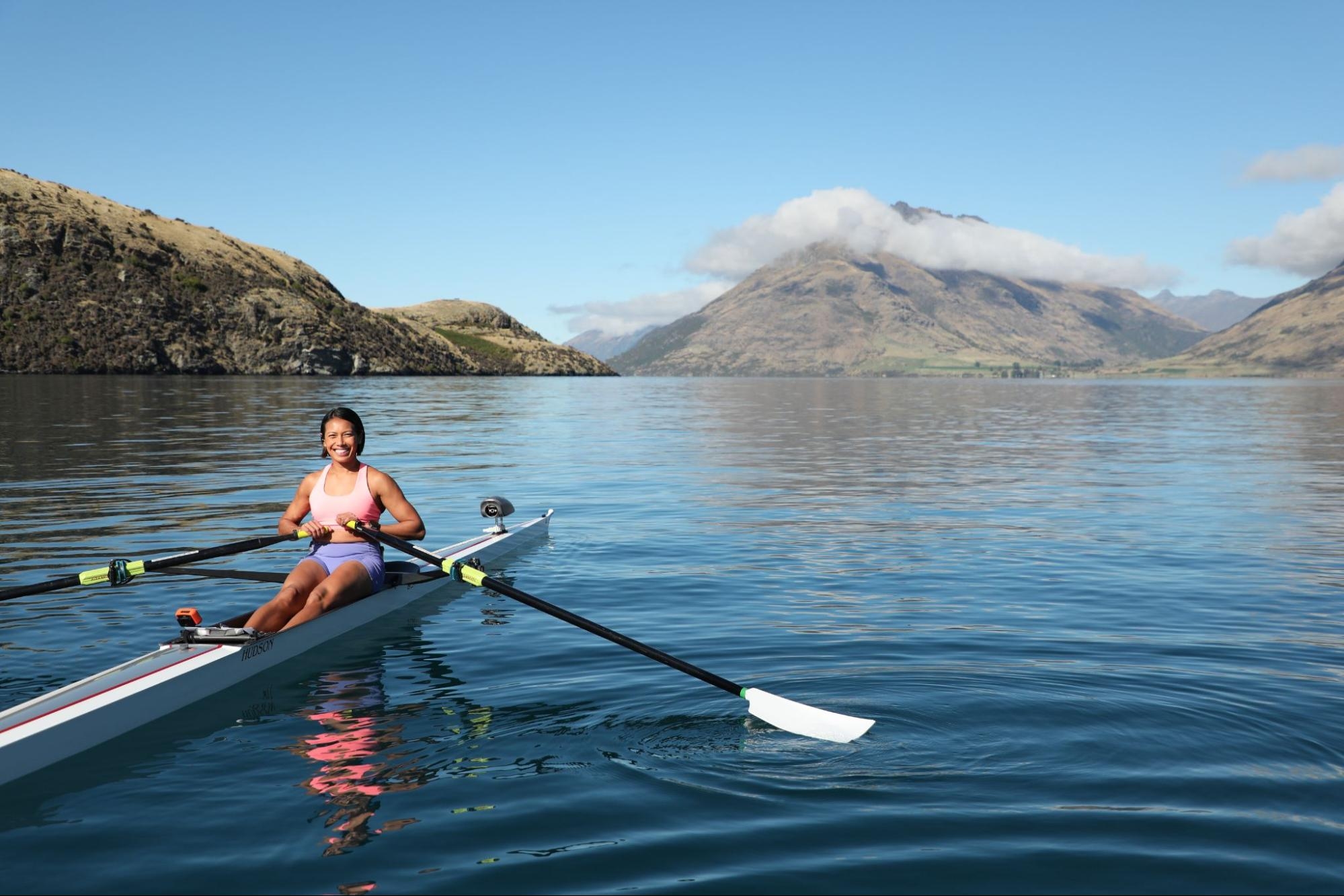 Hydrow Athlete rows in New Zealand as part of a Hydrow rowing machine workout.