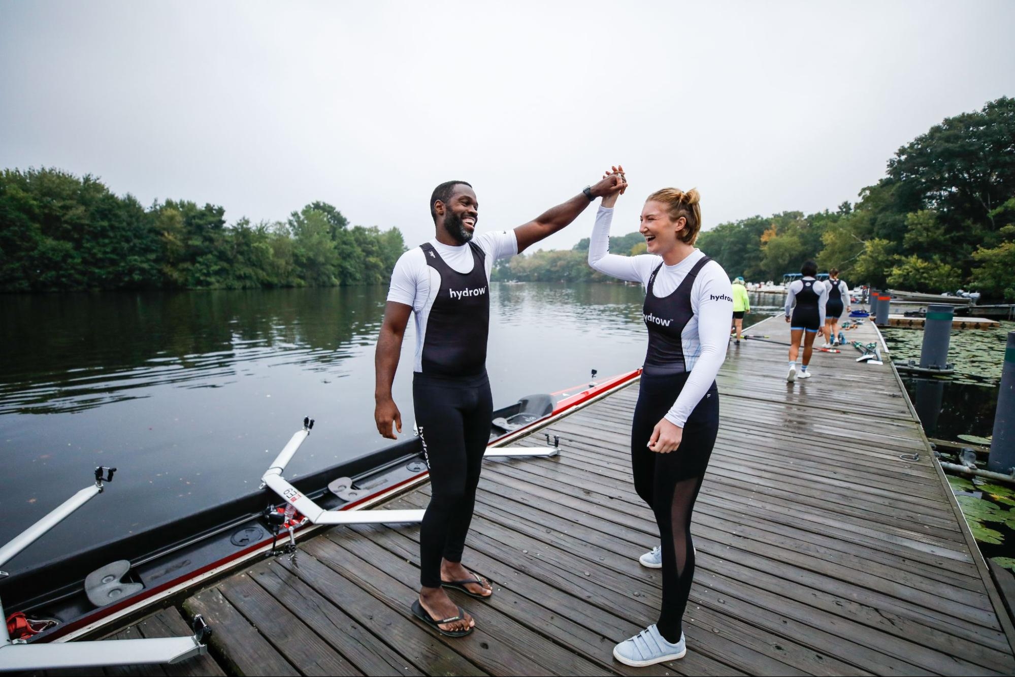 Hydrow Athletes Aquil and Dani high-five.