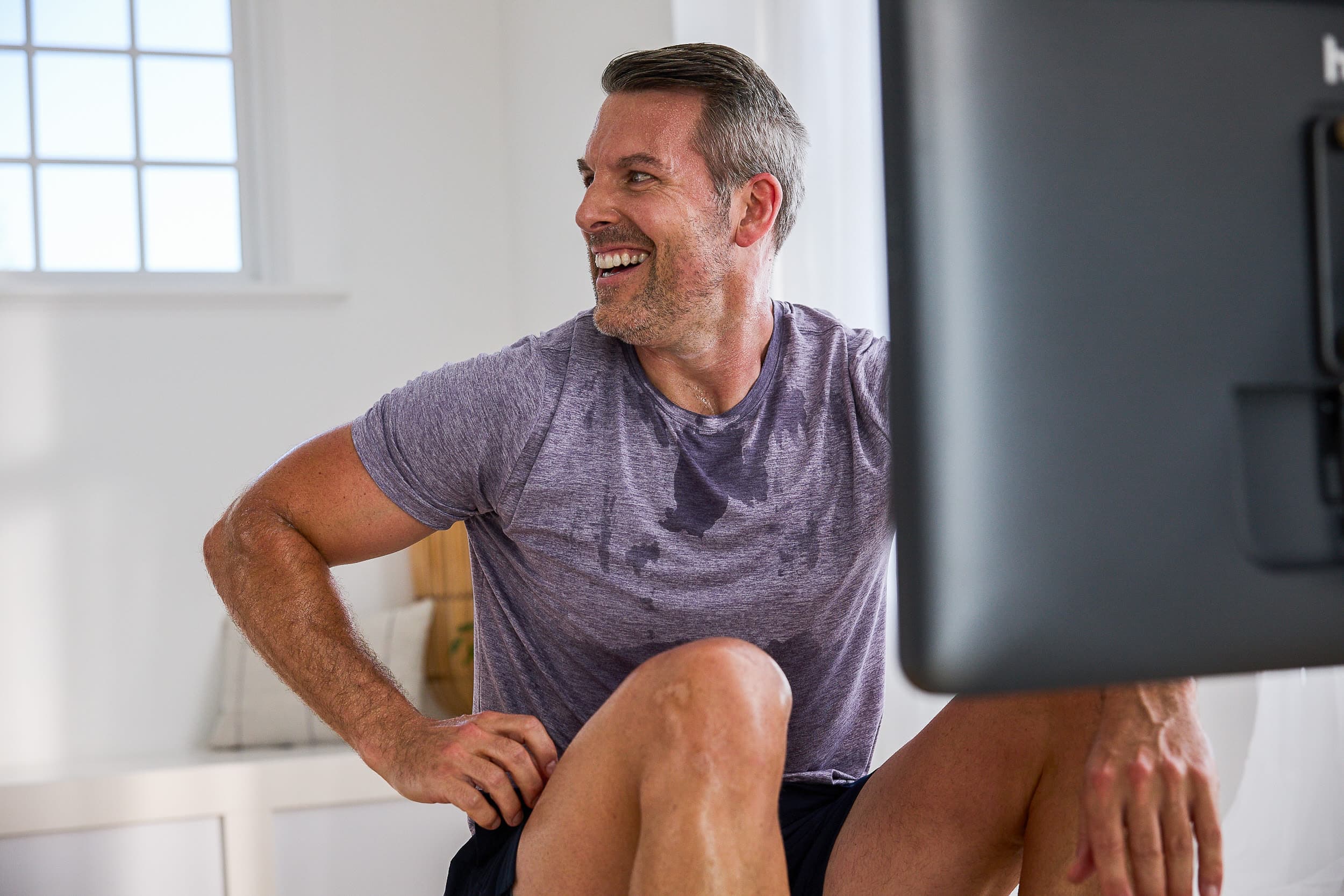 Man rows on a rowing machine to improve his heart health