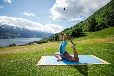 Man does a yoga workout after learning what yoga is and how to get started with his practice.