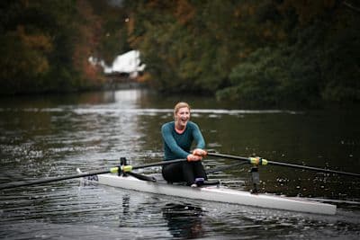 Woman does a rowing workout after asking, "Is rowing a good workout?"