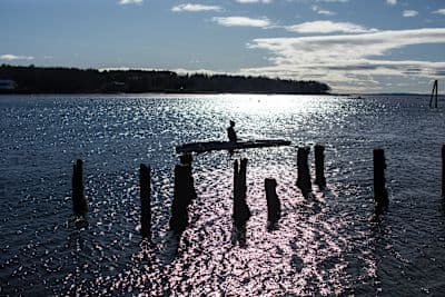 Woman rows on the water.