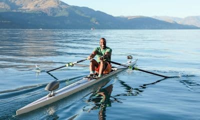 Man rows on the water after learning important rowing terms.