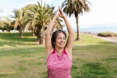 Older woman embraces active aging lifestyle by working out outdoors.