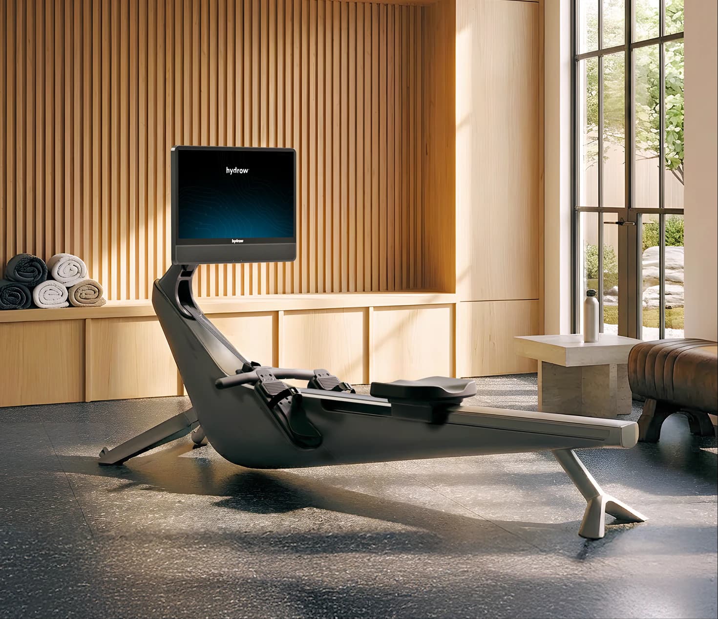 Hydrow rower in a sunlit wood-paneled home gym
