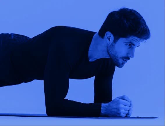 Man holding a plank on a mat
