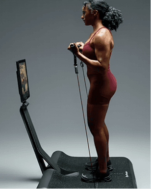 Side view of woman doing bicep curls on LYQUID