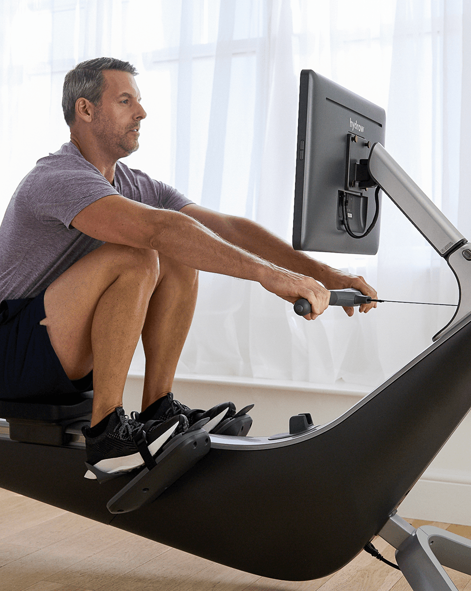 A Hydrow member rowing at home during a daily workout