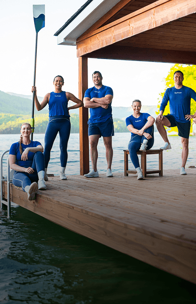 Hydrow Athletes together on a dock by the water