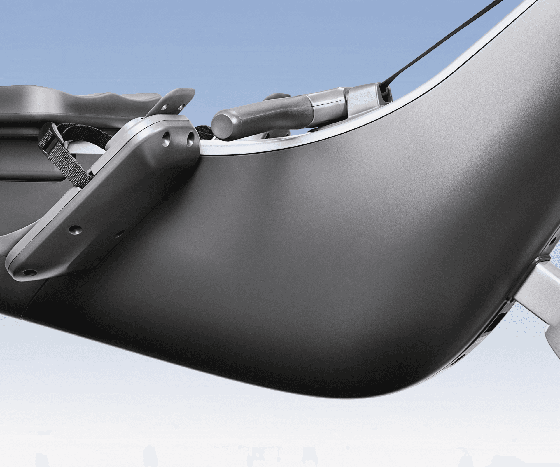 Hydrow Origin rower close-up, showing its sleek dark gray body, footrests, and handle.