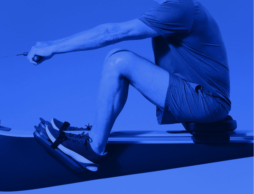 Man on Hydrow Rower in mid-stroke