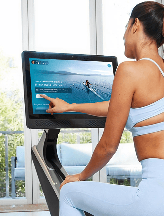 women choosing a workout on the Hydrow rowing monitor