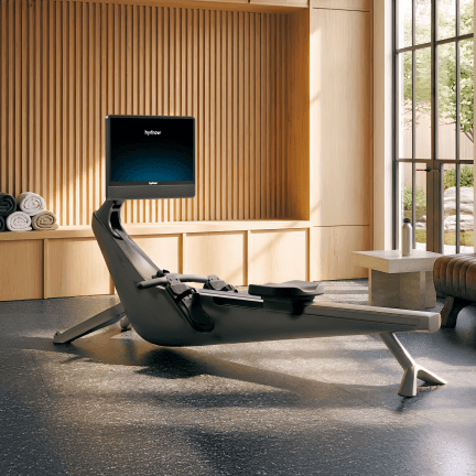 Hydrow Arc in a sunlit studio with a slatted wood wall