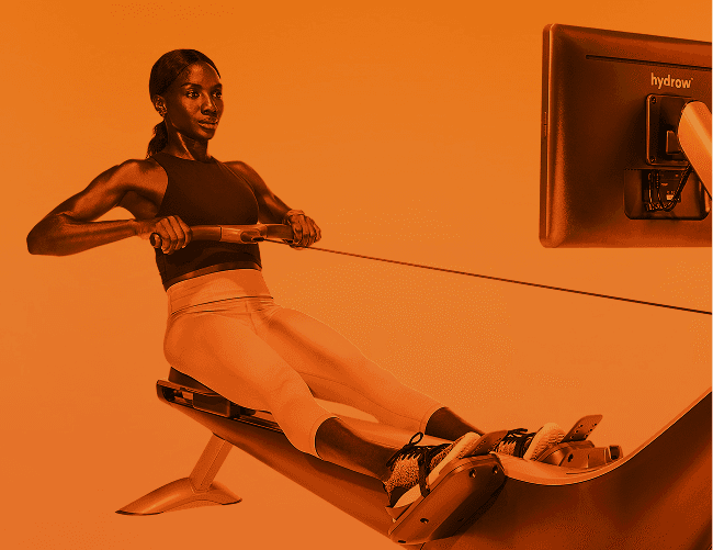 Woman on Hydrow Rower in mid-stroke